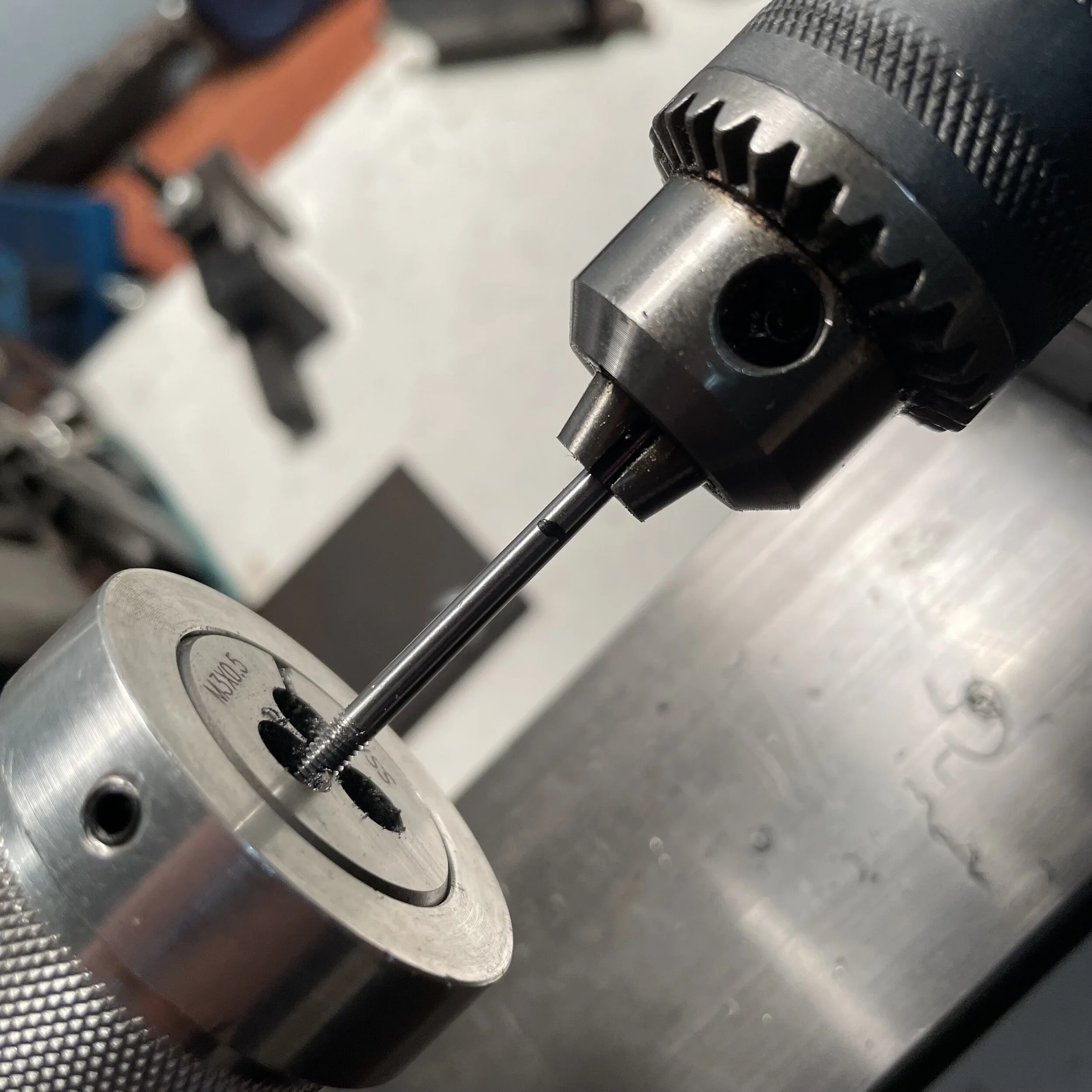 Threading the screw for my button is the next step. This is easily done on a mini lathe with a few attachments. I thread one end to secure it to the button and the other to progress into the eyelet.