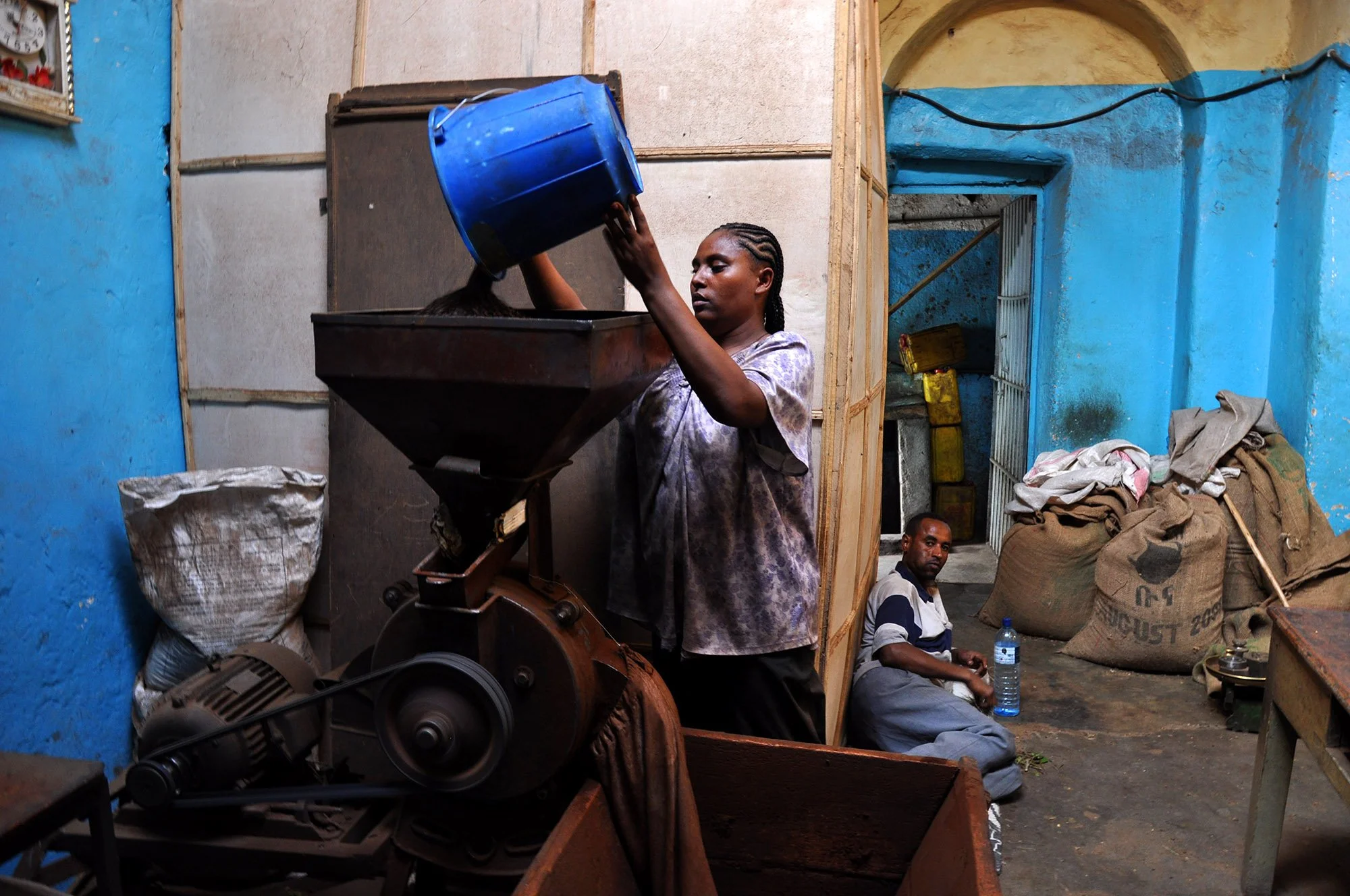  Visiting this coffee roastery was the highlight of my time in Harar (or a close second after watching a guy feed hyenas raw meat from his mouth). The gentleman relaxing on the floor while the lady does the heavy lifting has a mouthful of qat, so he'