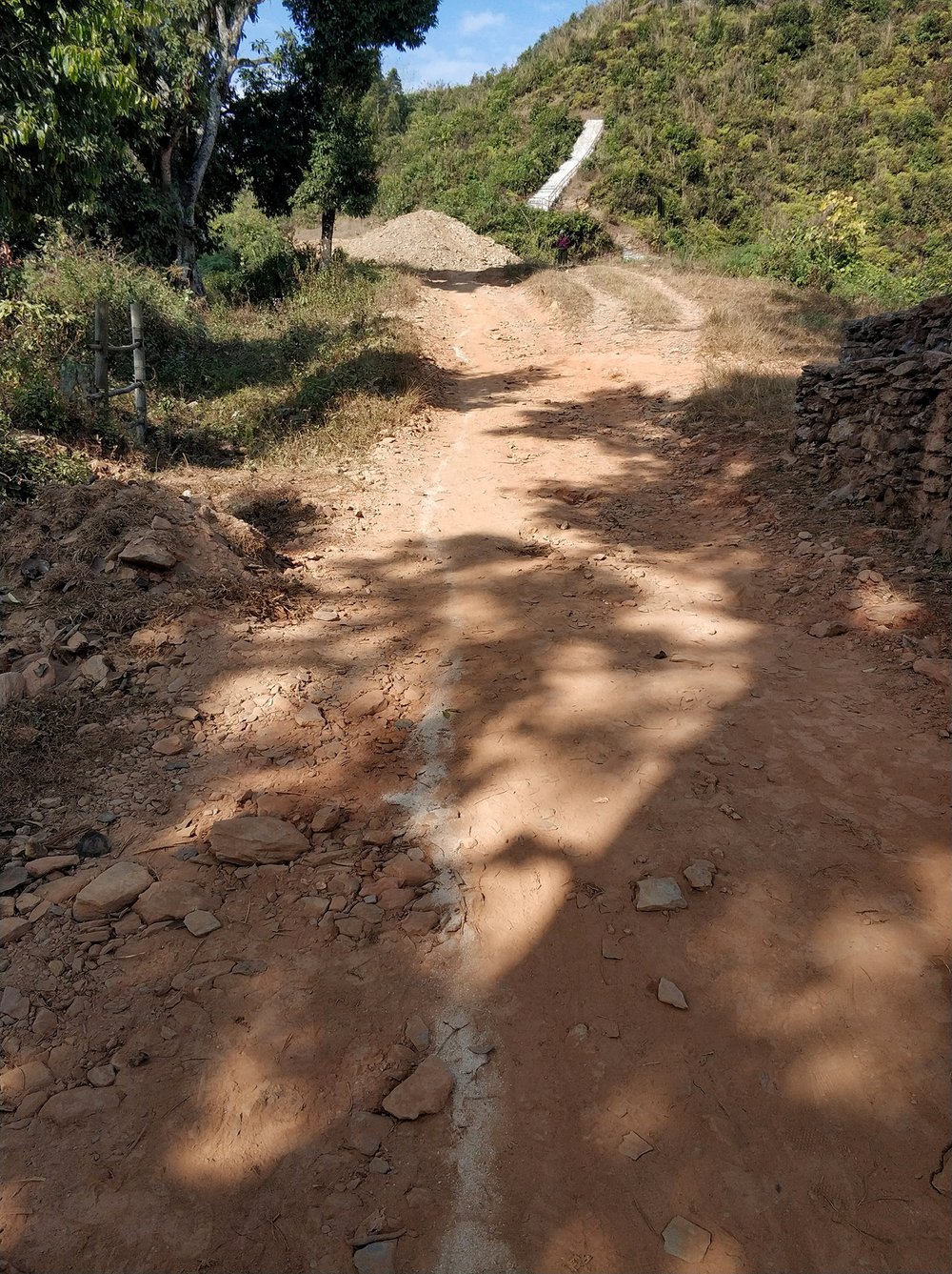  Pretty sure this was the first time we'd ever seen a dirt path with a dividing line before, which was amusing both because it's a dirt path in the middle of nowhere and because this is Nepal and dividing lines on roads are practically nonexistent ev