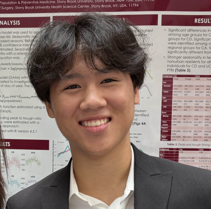 A young man in a white shirt smiling and holding a small electronic project with wires and components. The background has a banner with the text 'City College of New York STEM Institute' and related scientific icons.