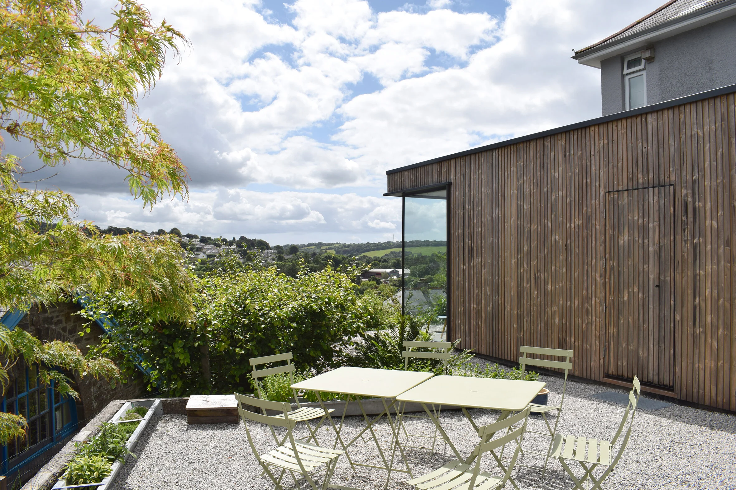 Contemporary timber-clad house extension at Rocky Hill, Tavistock, Devon, with large corner glazing overlooking the Dartmoor landscape