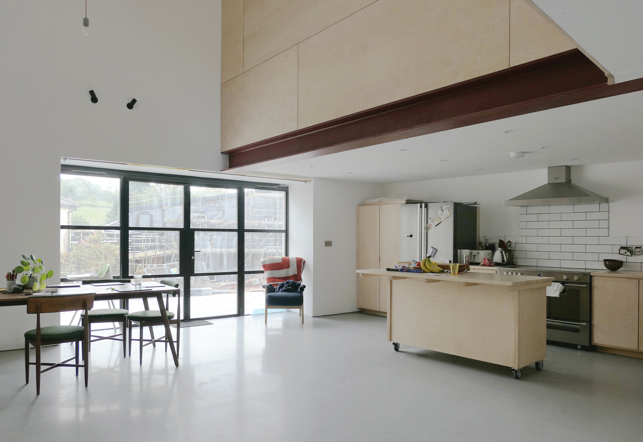 Contemporary barn conversion interior at Big Barn, Stokeinteignhead, Devon, featuring exposed steel beams, timber finishes and a double-height living space