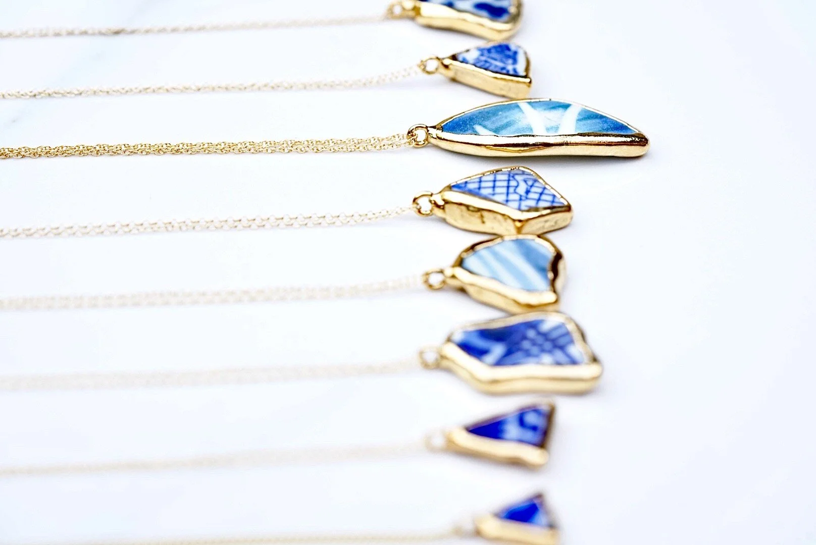 A selection of gold dipped sea pottery necklaces.