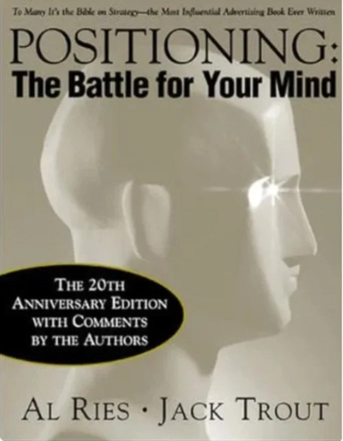 Book cover titled "Positioning: The Battle for Your Mind" with a profile of a human head in a metallic or shiny material, showing the side of the face and head.