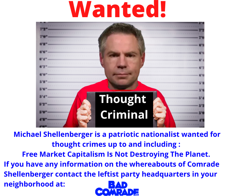Wanted poster featuring a man with short, dark hair, wearing a red shirt, holding a black sign that says "Thought Criminal" in white text. The poster has a height measurement background, red "Wanted!" text at the top, and blue text below describing Michael Shellenberger as a patriotic nationalist wanted for thought crimes, with contact info for the leftist party headquarters.