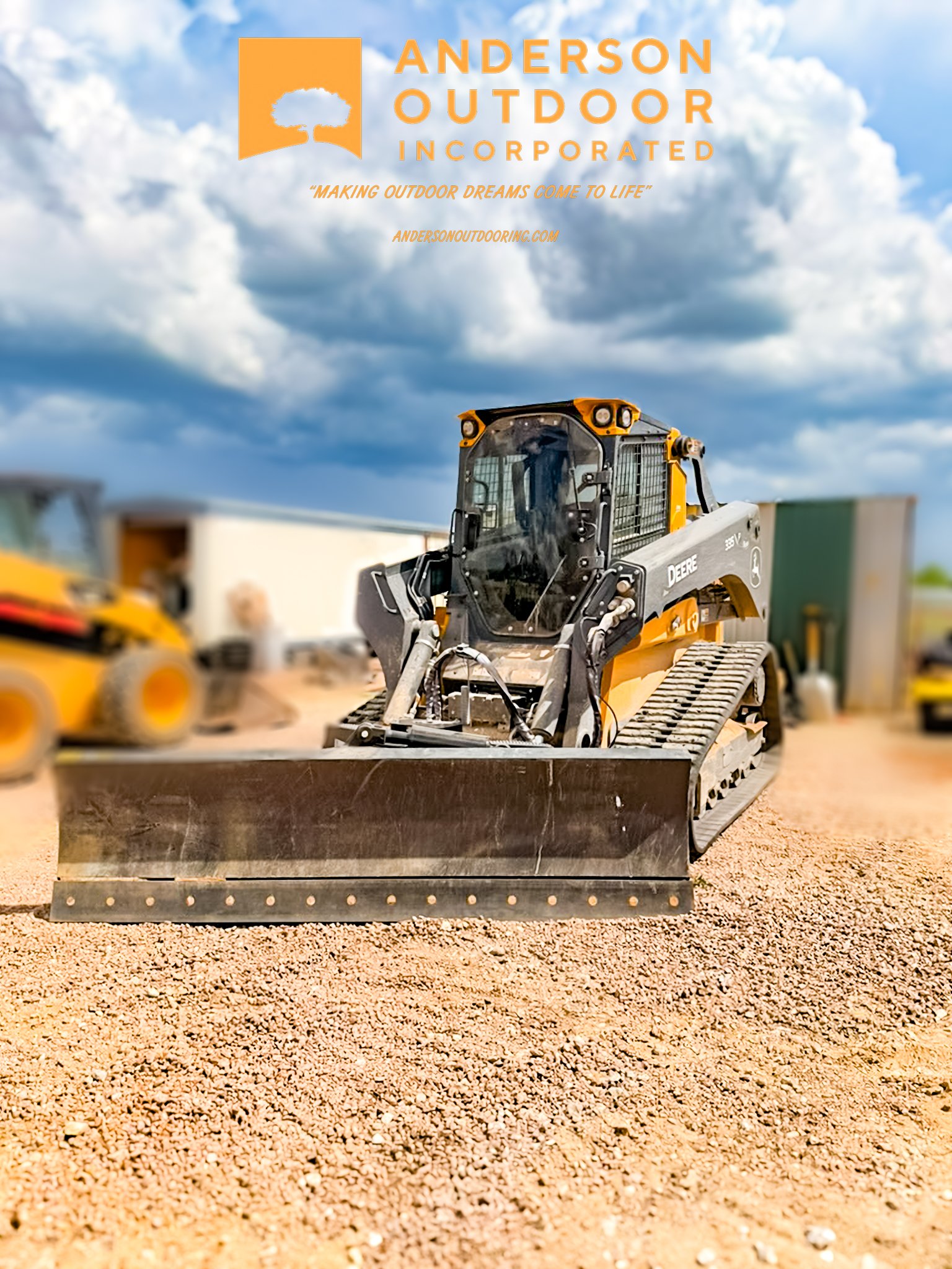 A piece of construction equipment, a small bulldozer or skid steer loader, sits on dirt at a construction site under a cloudy sky with some buildings and other machinery in the background.