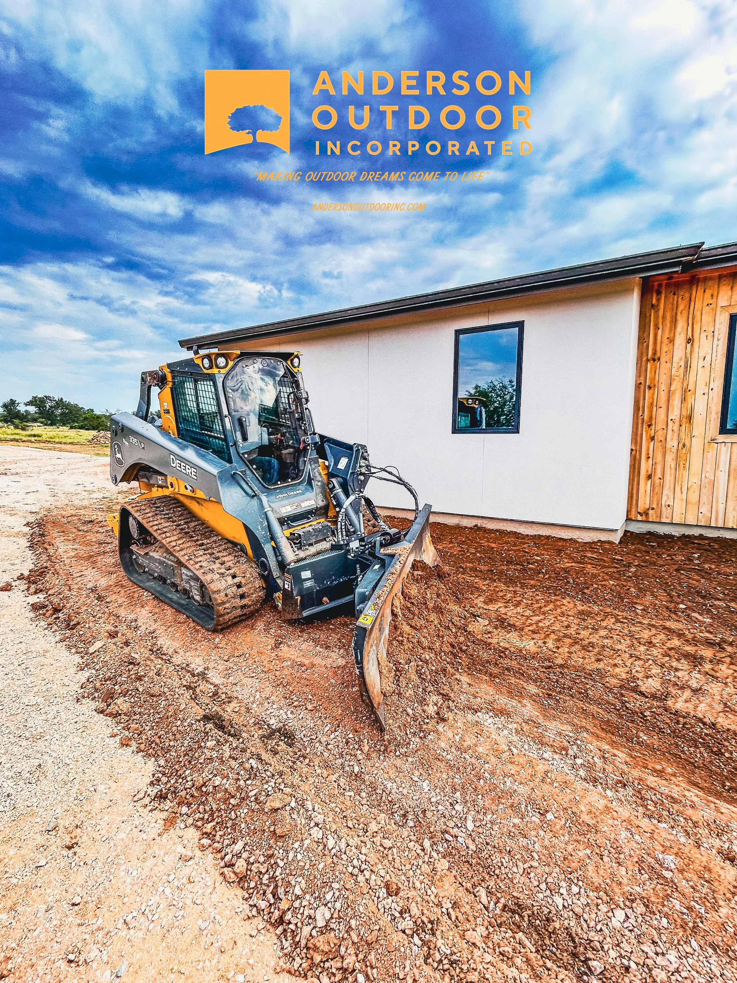 Construction site with a small bulldozer in front of a building with white and wooden siding, under a partly cloudy sky, and Anderson Outdoor Incorporated logo and text at the top.