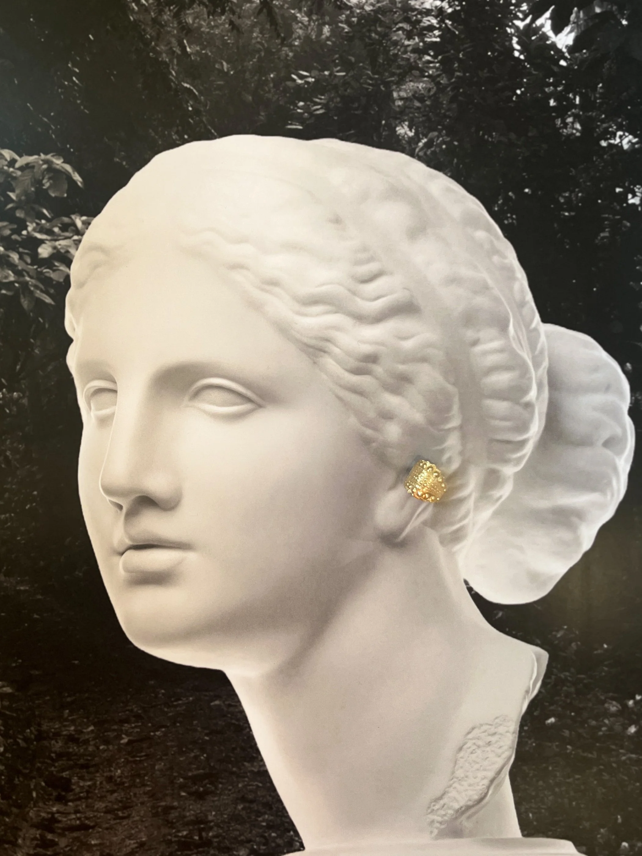 textured gold vermeil ear cuff cast from sea urchin shell displayed on classical bust