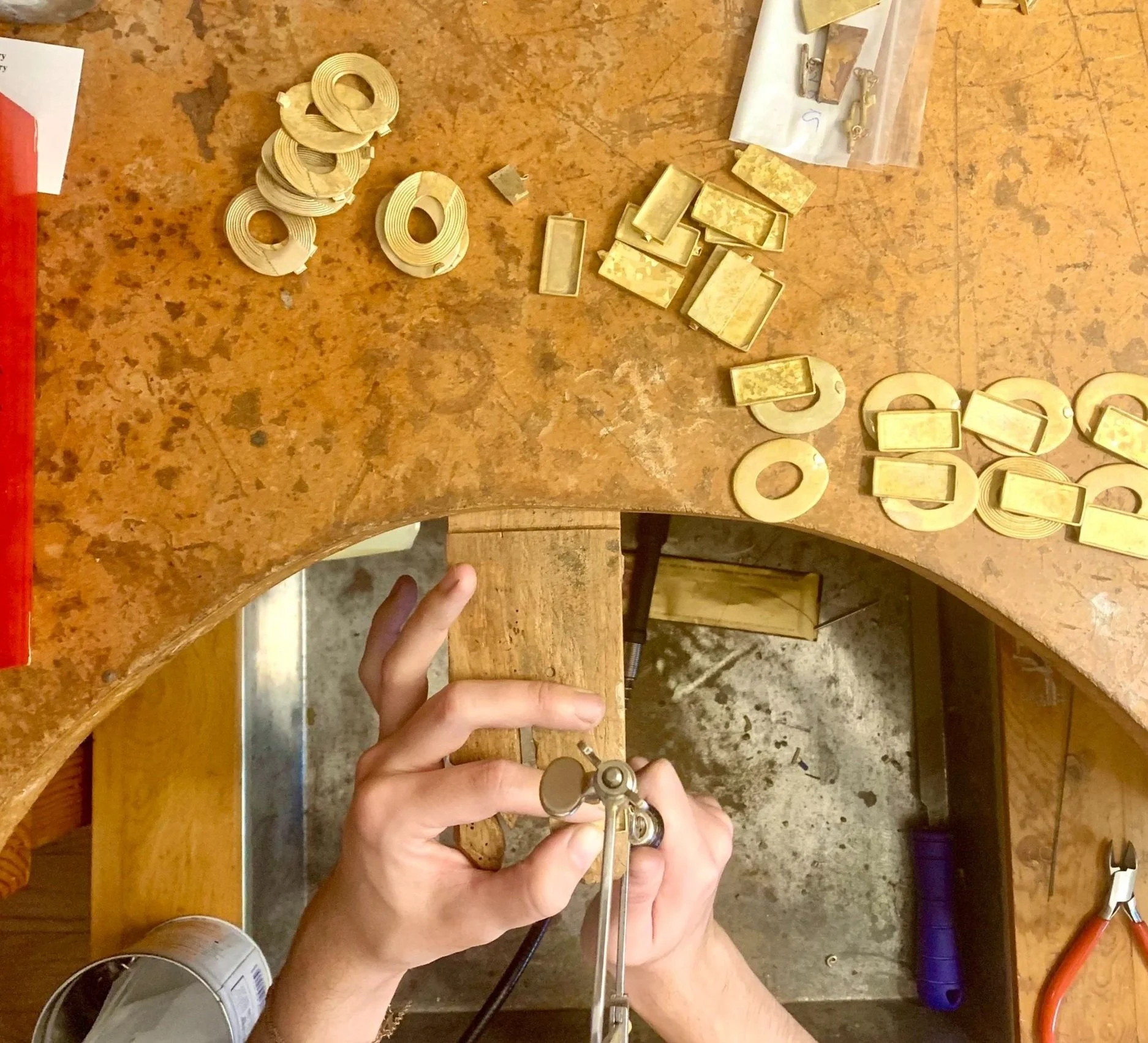 Jewelry designer and artist Stephanie Alman at her jewelry bench in Brooklyn, New York City - a top down view of her tools and materials
