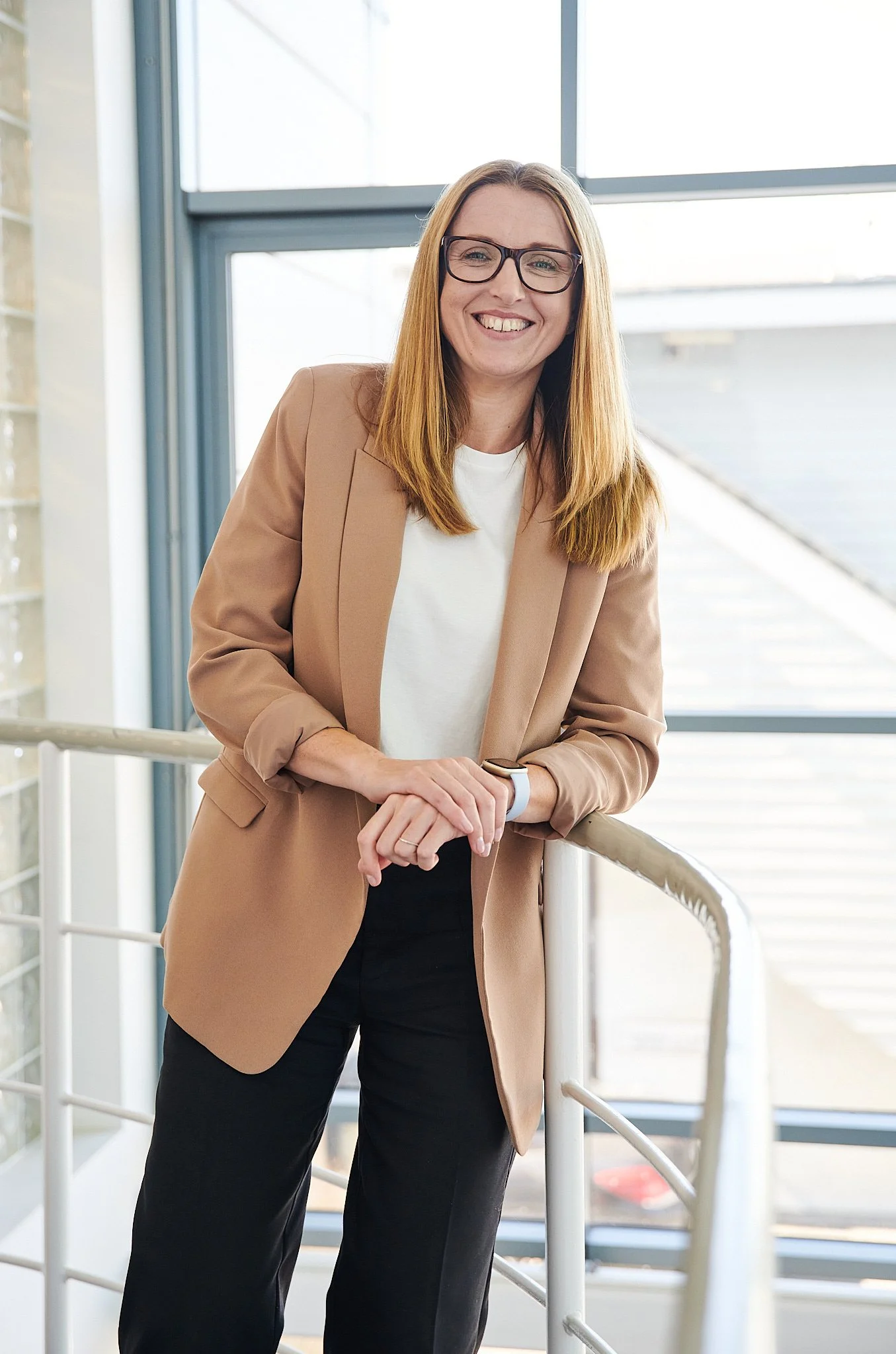 company portrait shoot standing infront of large window