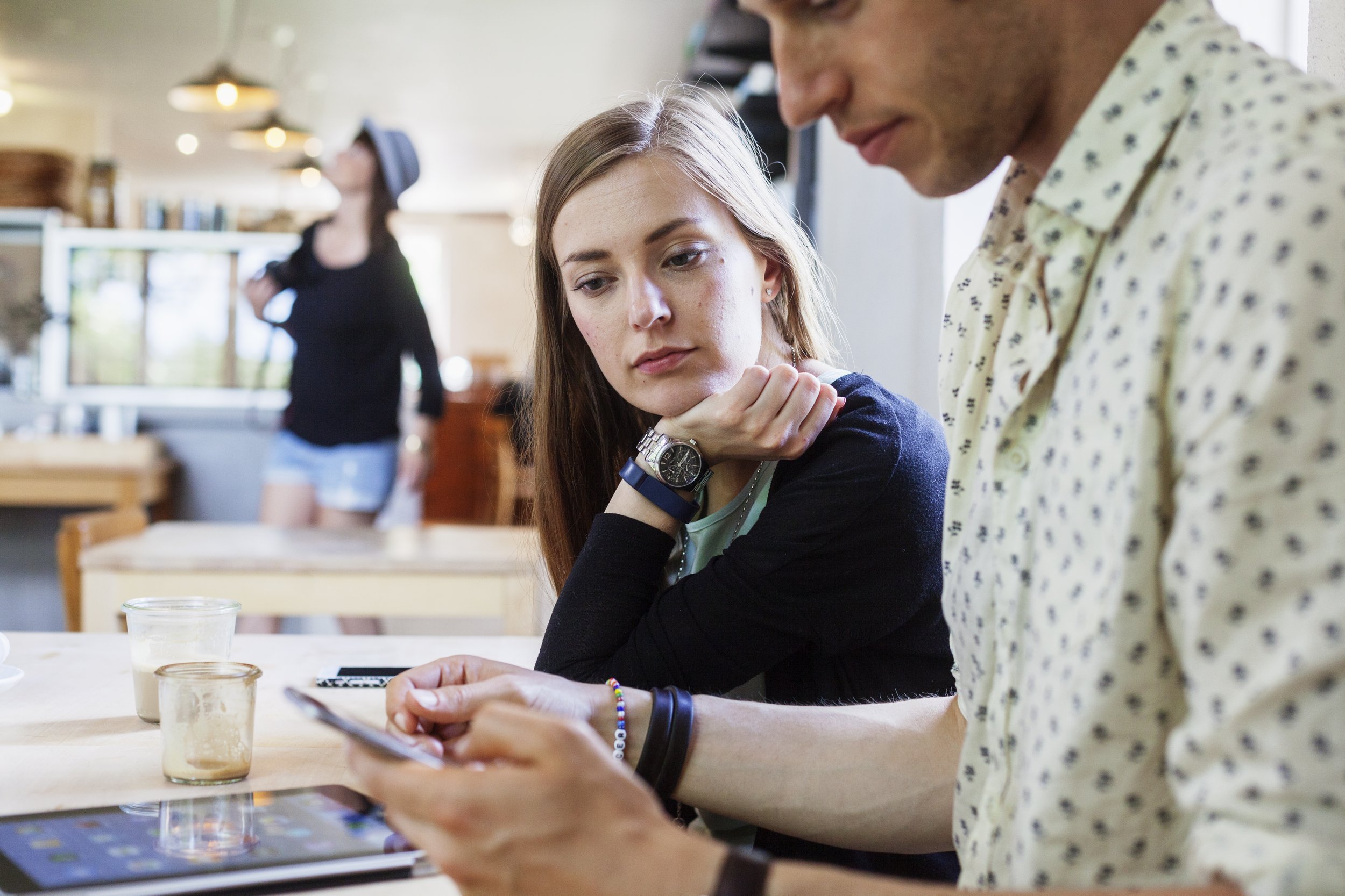 two young colleagues reviewing a smartphone together