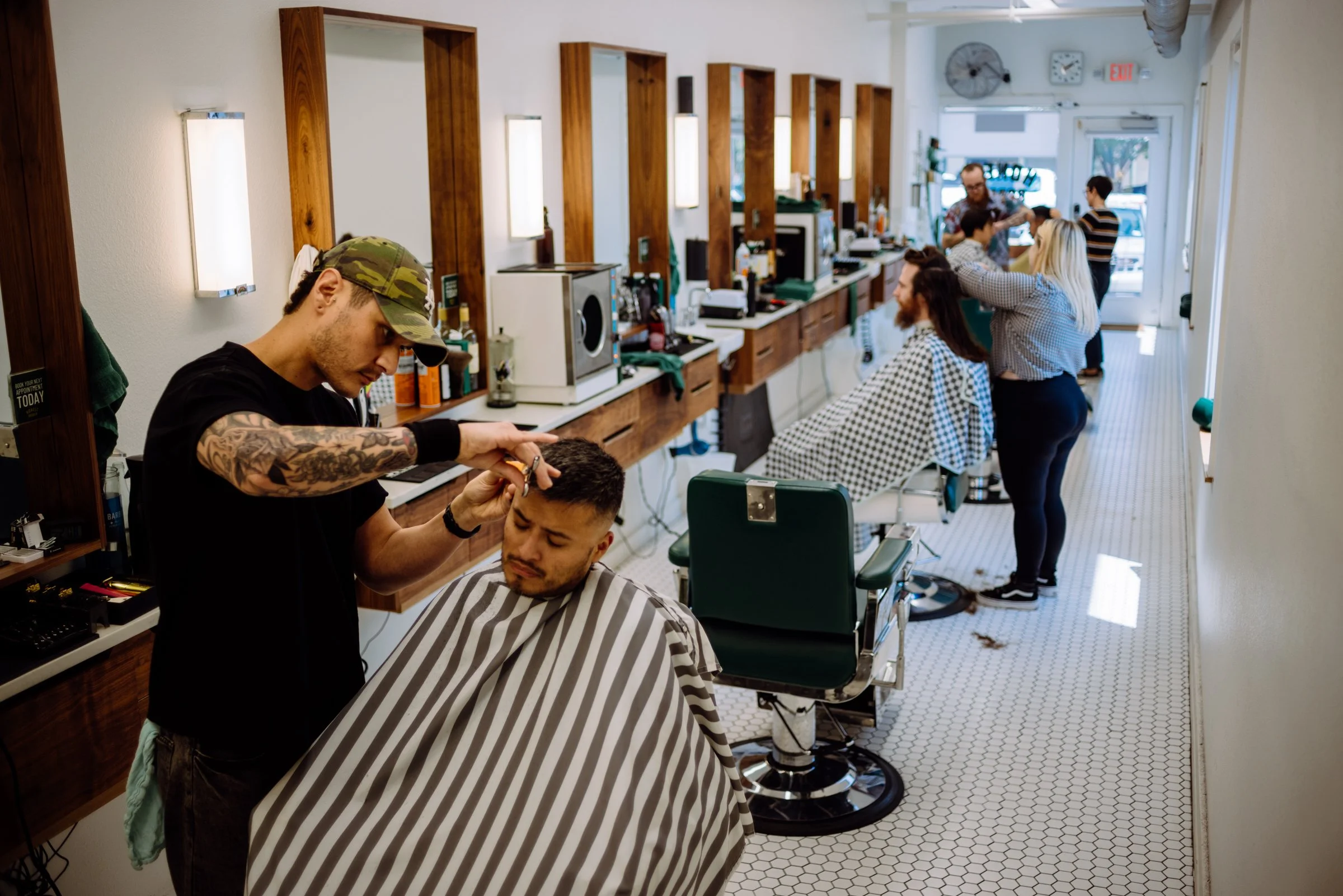 Austin barber shaping a clean fade haircut on a client at Honest Barber men’s barbershop.