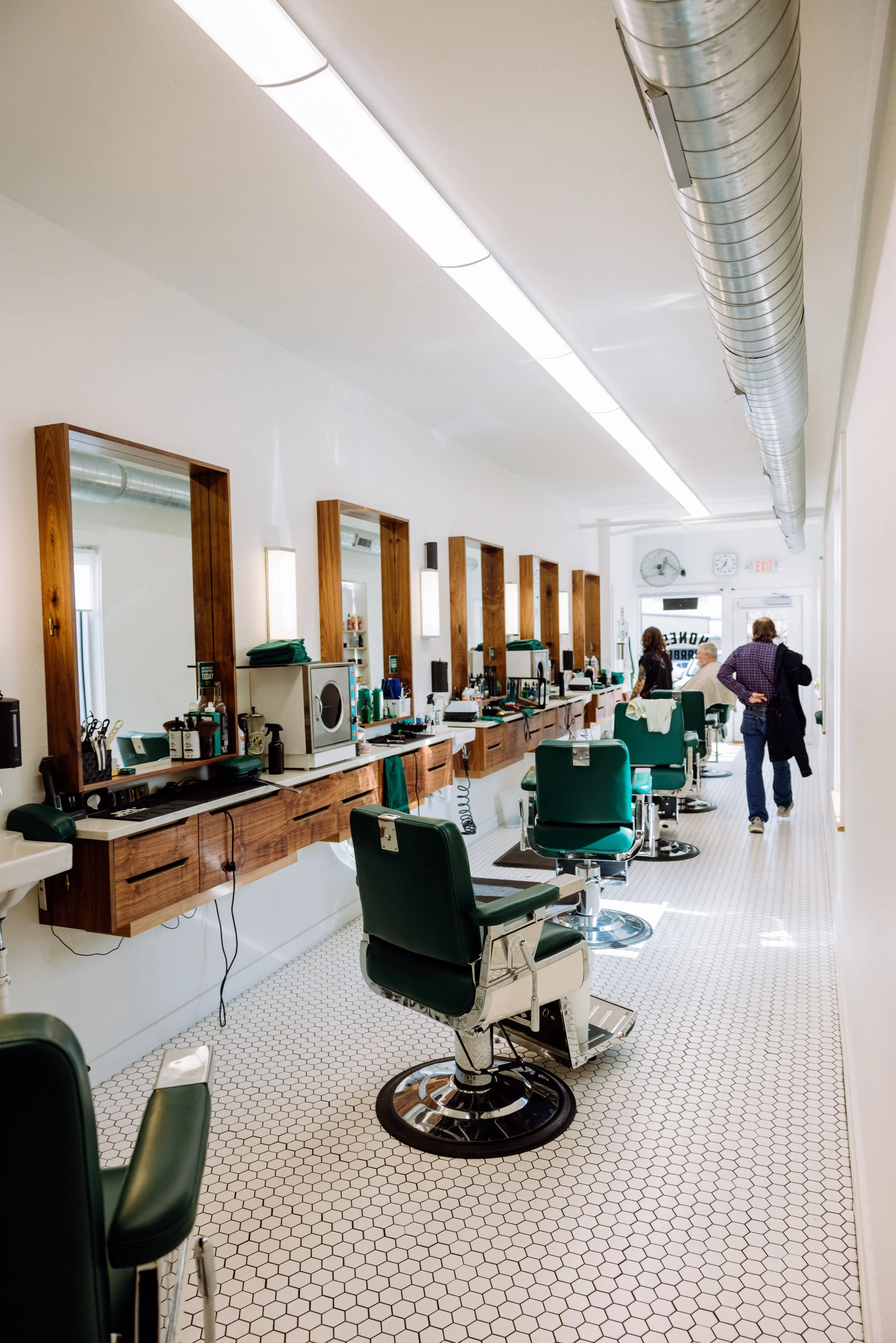 Bright interior of Honest Barber barbershop in Austin Texas highlighting clean design and professional grooming space.