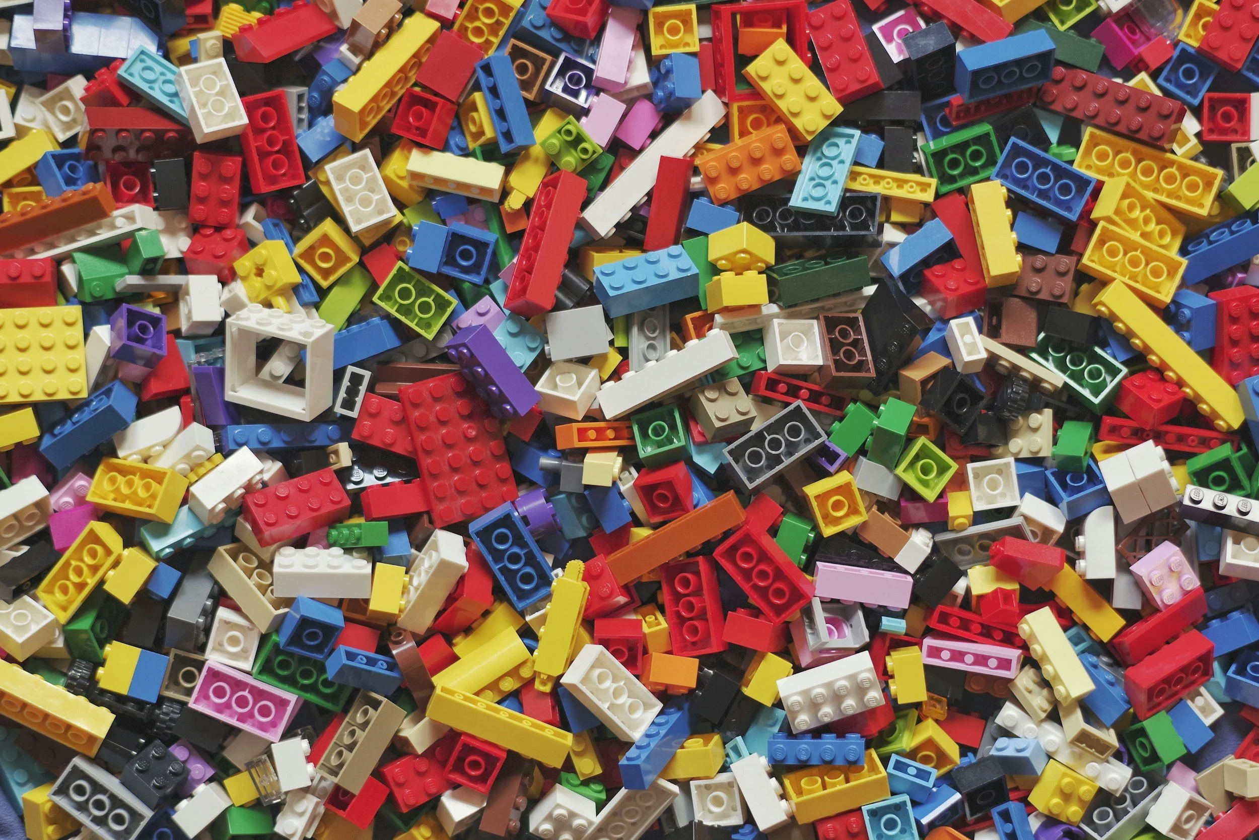 A large pile of colorful LEGO bricks in various shapes and sizes. Lego Camp