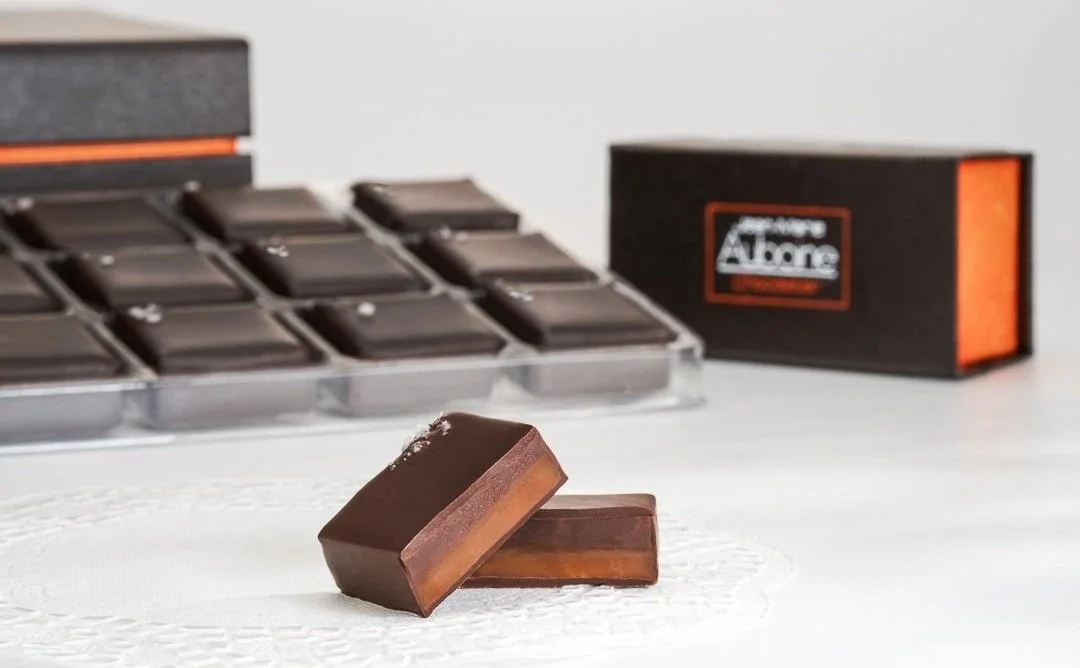 Gourmet chocolate box featuring Jean-Marie Auboine Chocolatier's signature Double Sea Salt Caramels.