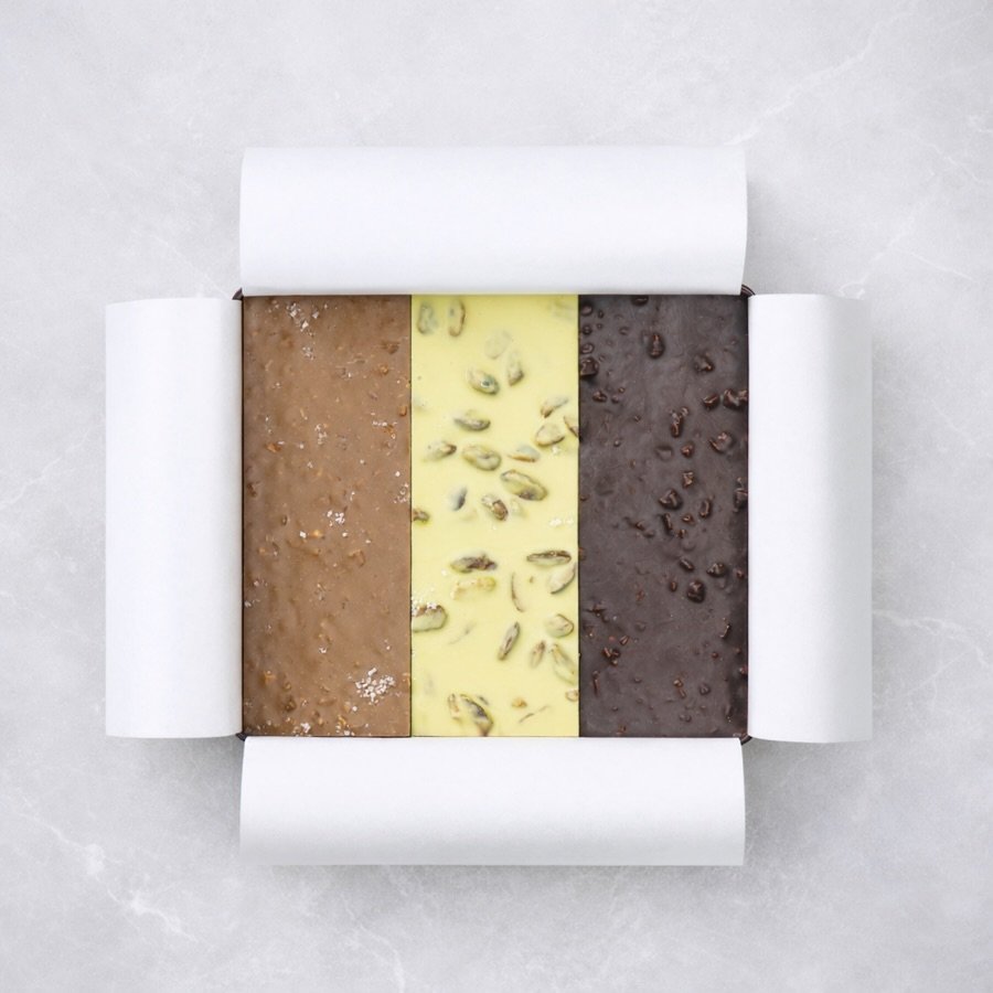 Our bark has a new packaging! Available in three delicious flavors: 
- Caramelized Almond Dark Chocolate 
- Caramelized Hazelnut Milk Chocolate
- Pistachio White Chocolate

What&rsquo;s your favorite one? 
#chocolate #bark #pistachio