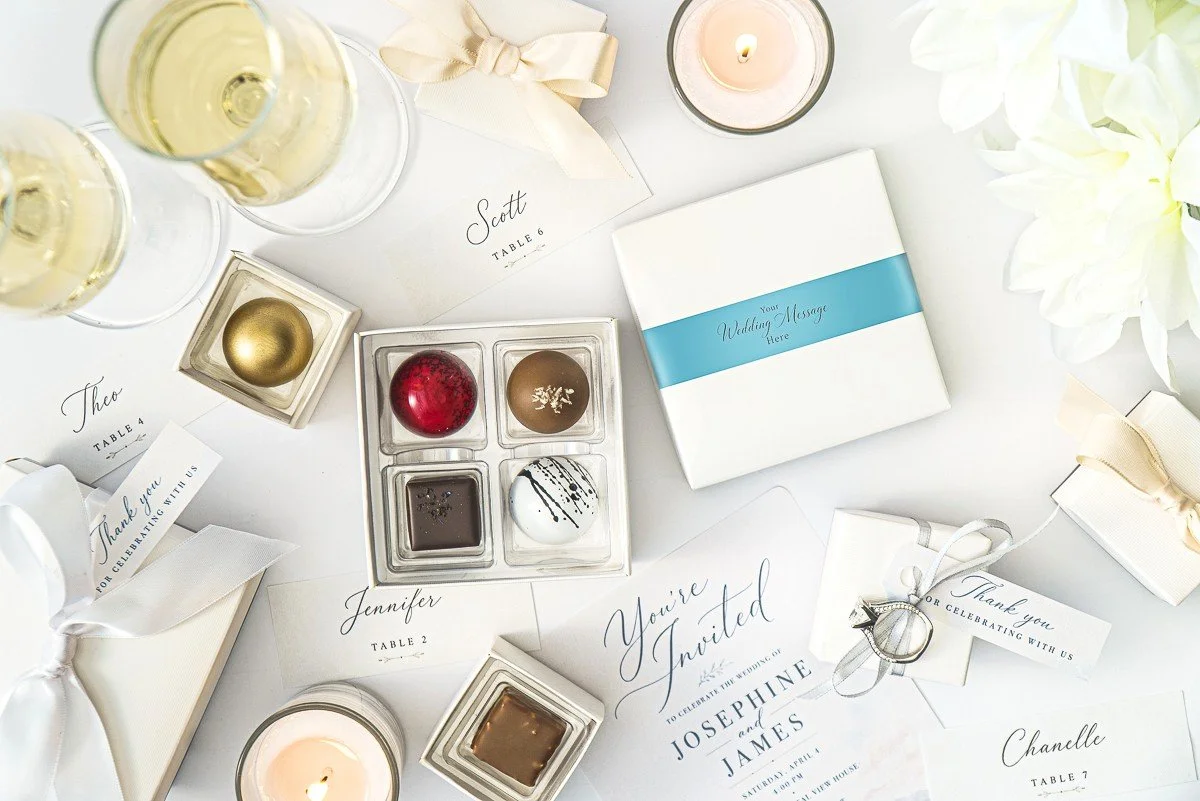 4pc white box filled with premium chocolate bonbons by Jean-Marie Auboine Chocolatier perfect on a wedding table