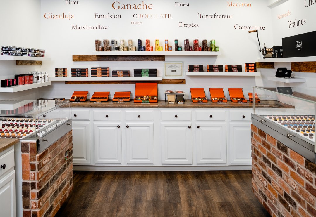 interior of Jean-Maie Auboine Chocolatier harmon avenue store full of chocolate boxes and free samples