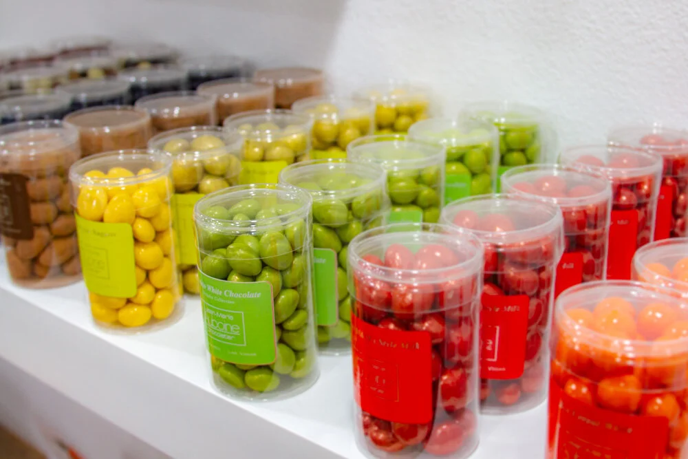 Shelf of colorful nut panning in chocolate