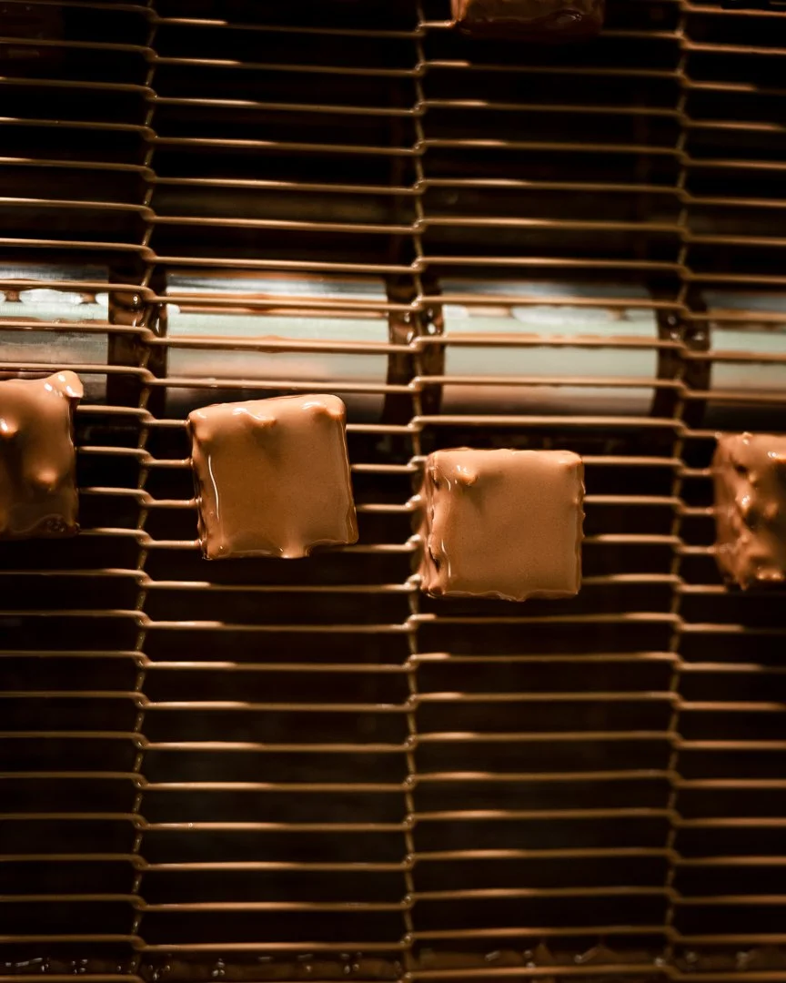 Chocolate Praline Being Enrobed in Premium Swiss Couverture Chocolate