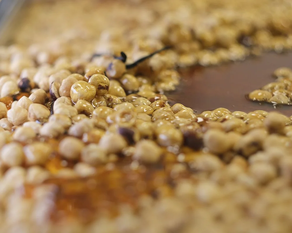 Roasted hazelnuts prepared for handcrafted hazelnut praline and chocolate creations.