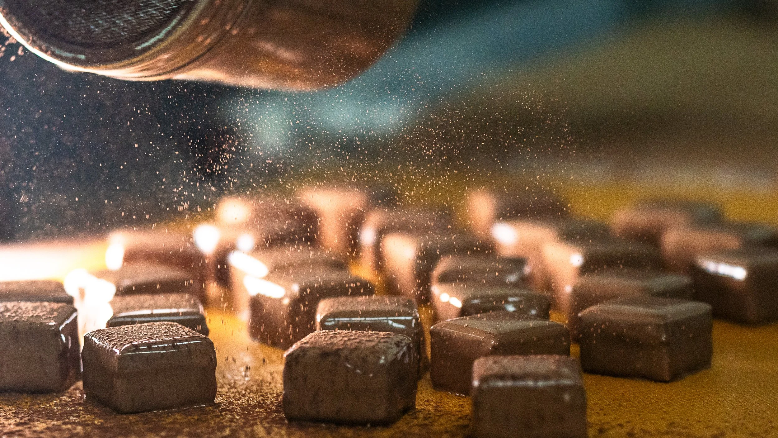Milk Chocolate Bonbon being covered in Cocoa powder for decor