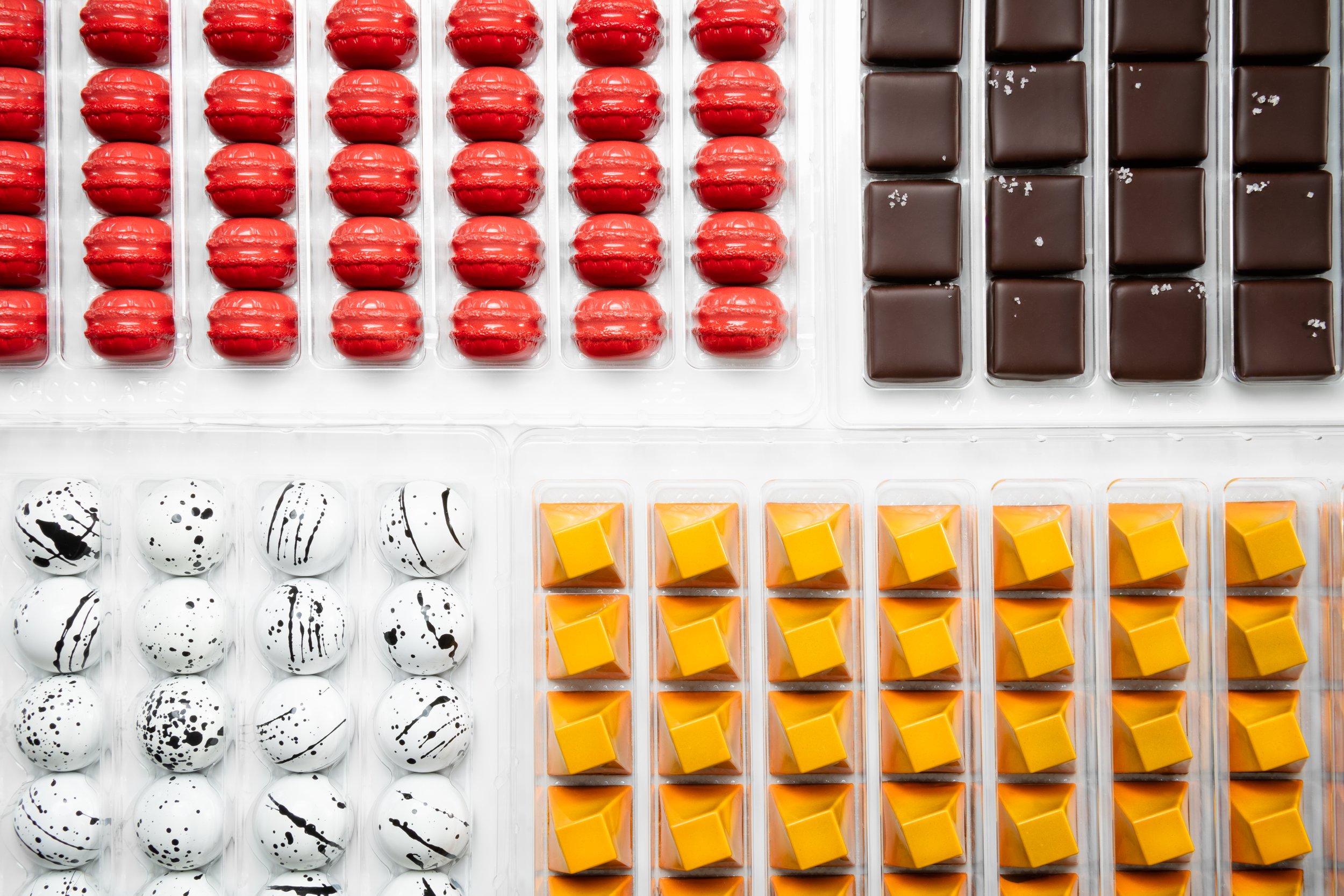 trays of 4 types of different chocolate bonbons: De Sel, Passione, Ouessan and Amore