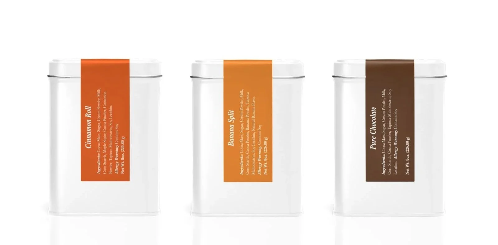 Premium drinking chocolate tins trio in Cinnamon Roll, Banana Split, and Pure Chocolate gourmet flavors.