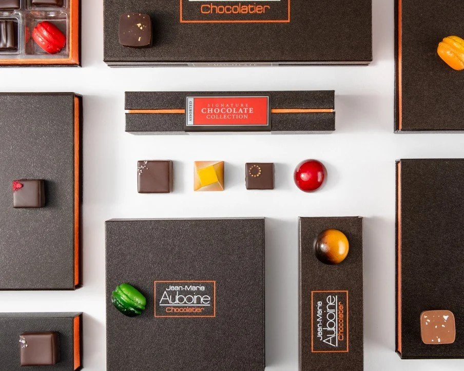 Luxury signature chocolate collection featuring premium artisan bonbons in elegant gift boxes.