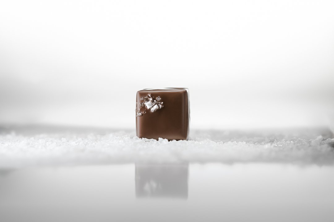 Double Sea Salt Caramels displayed on French Guérande fleur de sel, highlighting the signature finishing salt used in the recipe.
