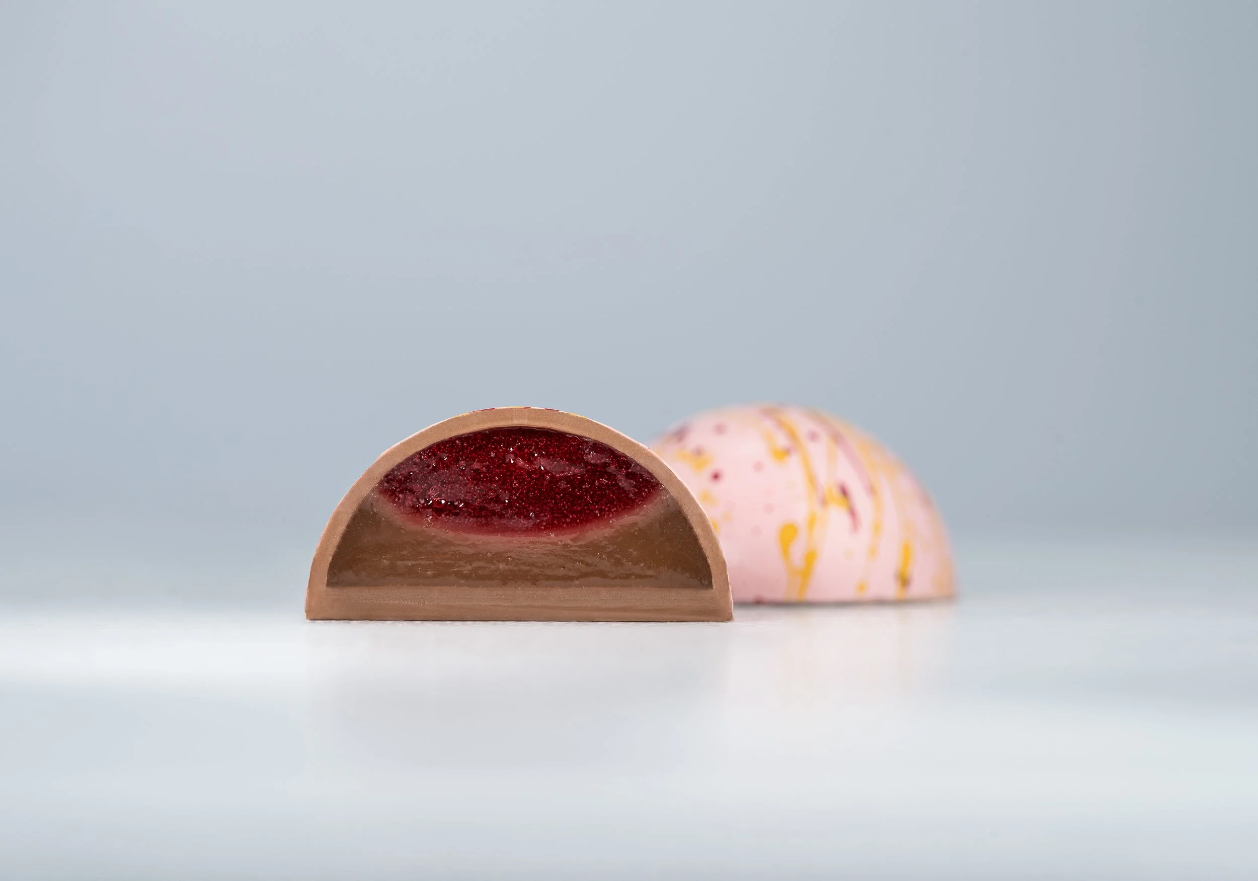 Handcrafted bonbon with fresh two flavors filling Peanut butter and jelly