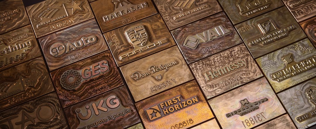 Custom logo embossing plates used for branded corporate chocolate gifts and personalized packaging