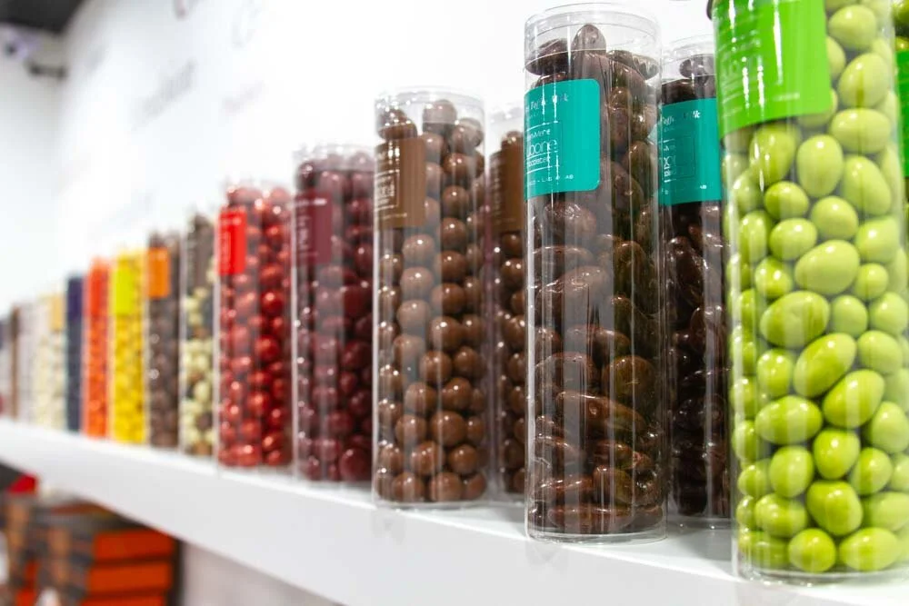 Shelf of colorful and delicious enrobed nuts in chocolate