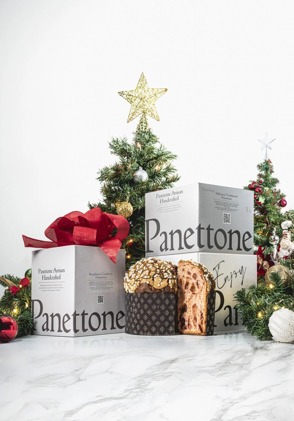 Luxury artisanal panettone displayed with premium gift boxes and festive holiday déco
