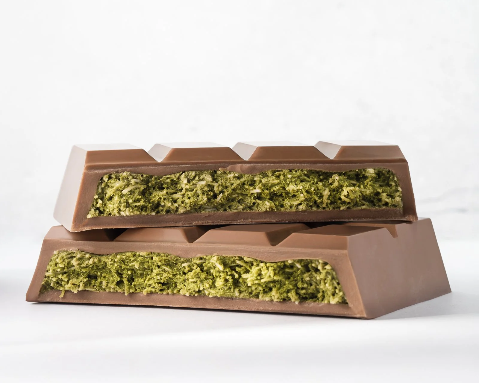 Dubai Chocolate Bar filled with pistachio, crispy kataifi, and tahini, showcasing one of today's most popular chocolate trends.