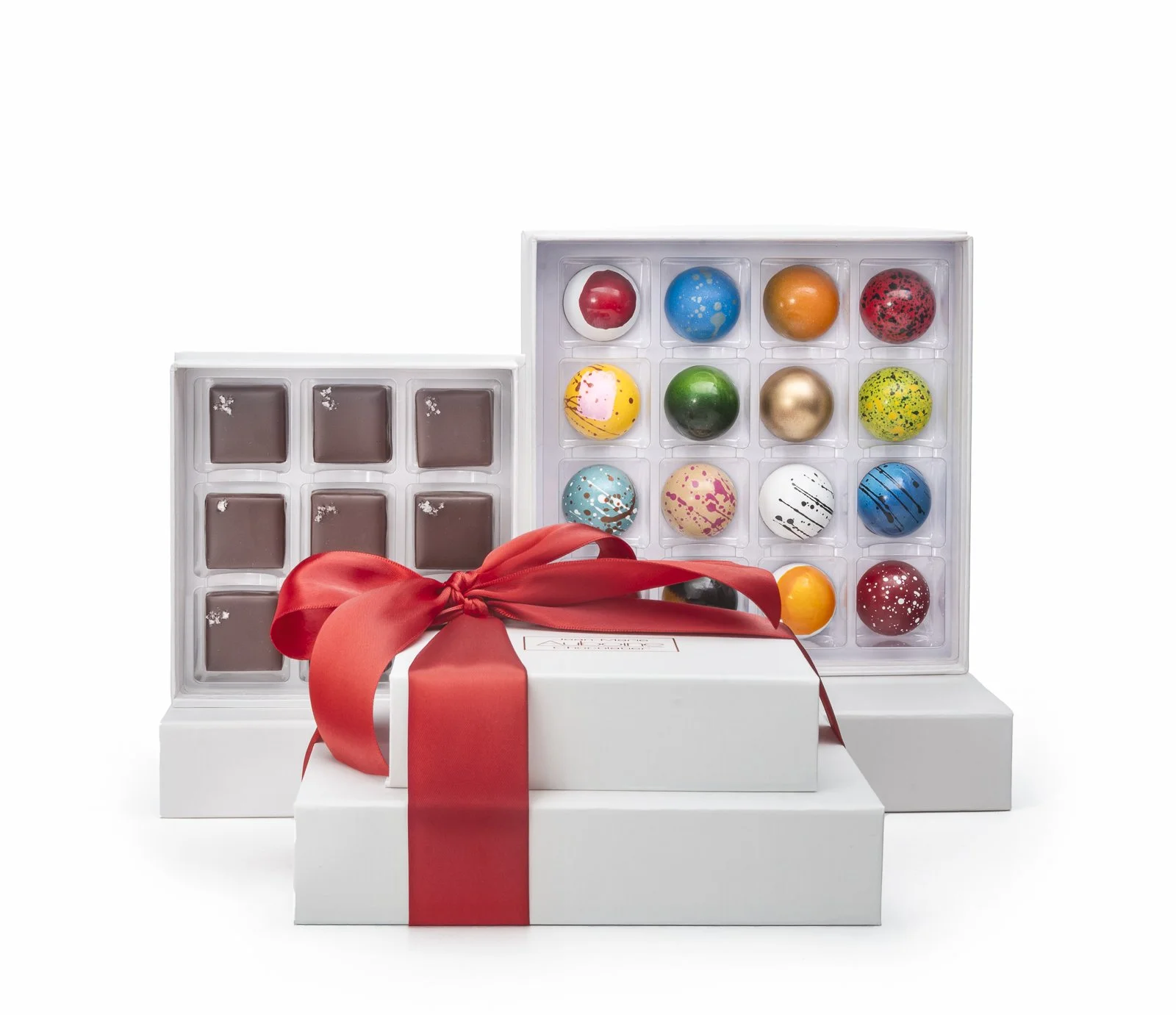 Signature chocolate gift tower with mixed chocolates and truffles, tied with a festive red ribbon