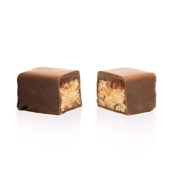 Cross-section of a Lion Bite showing layers of crispy rice, sea salt caramel, and milk chocolate in a nut-free version of the Lion Bar.