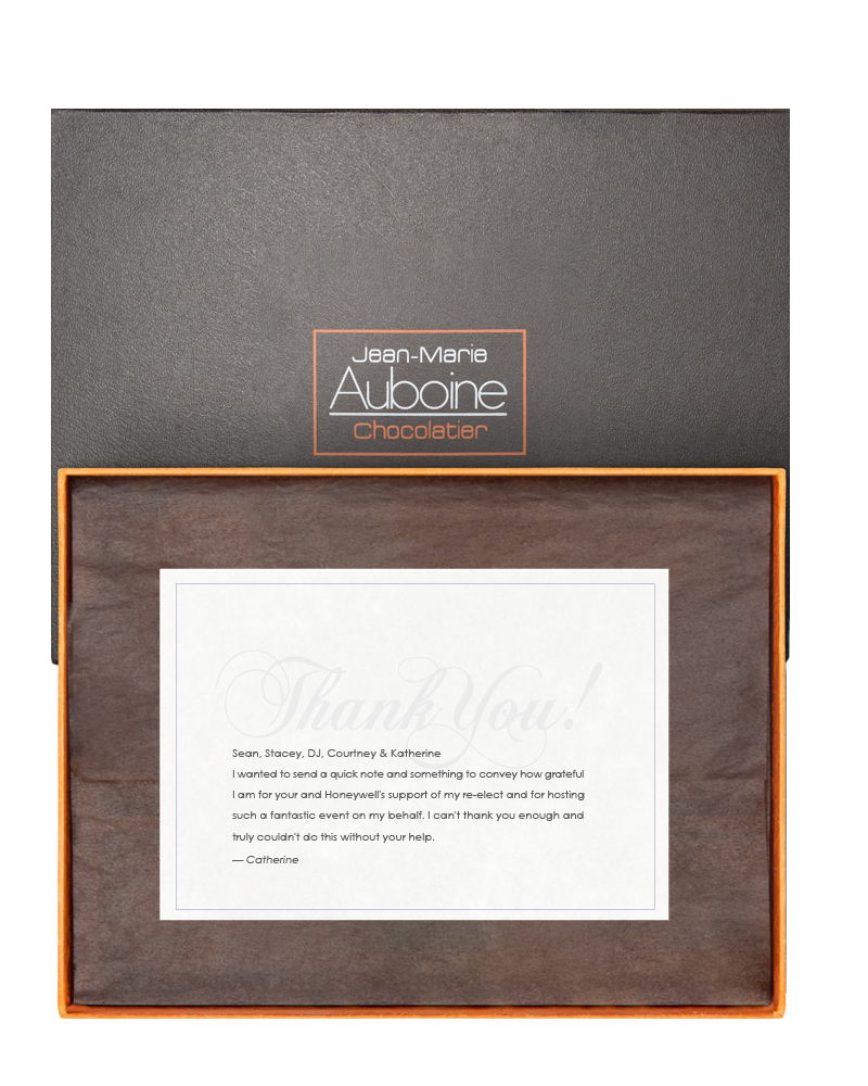 Open corporate gift box with personalized thank-you message insert for branded holiday gifting
