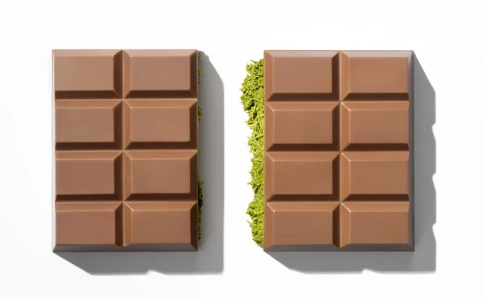 Split Dubai Bar revealing vibrant pistachio filling encased in premium milk chocolate.