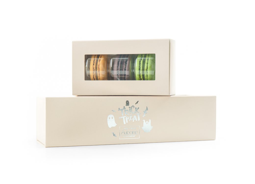 boxes of macarons for halloween with fall flavors and trick or treat stamp