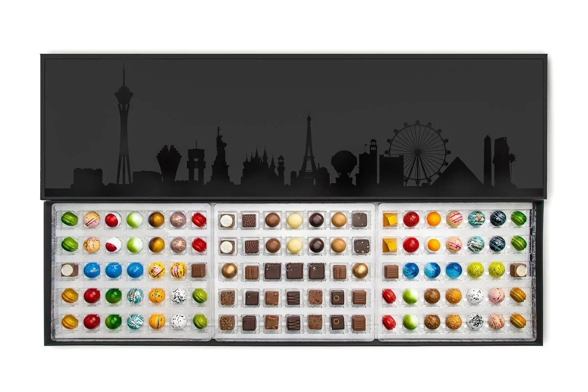Premium black Vegas-themed gift box filled with luxury artisan bonbons and colorful gourmet truffles