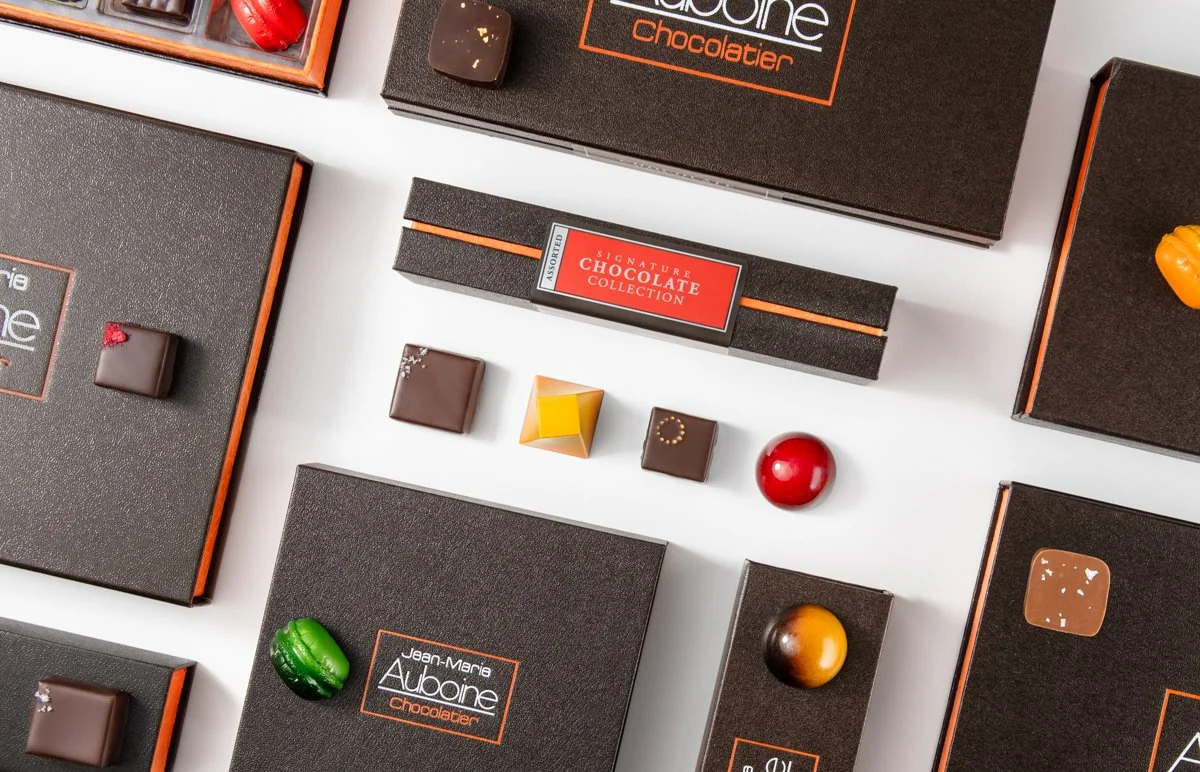 Display of the house elegant signature boxes filled with premium chocolate assortments