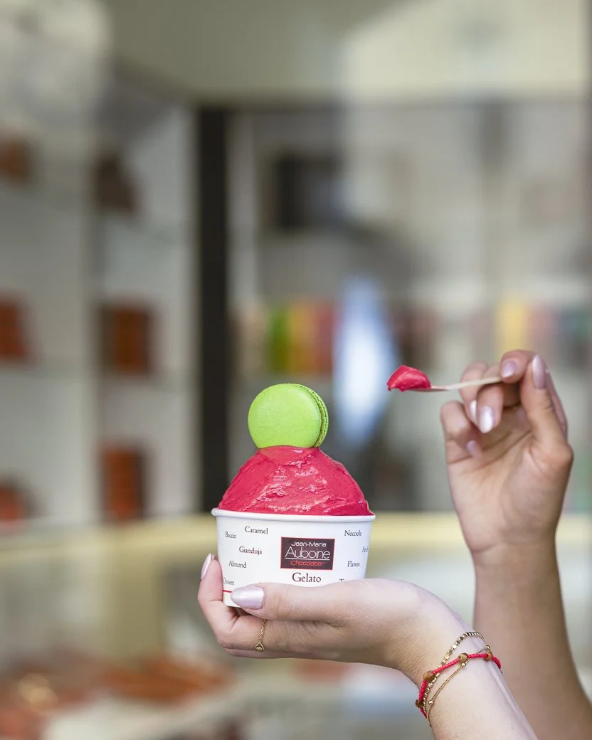 Raspberry gelato with a pistachio macaron in front of the jean-marie auboine  chocolatier tivoli store