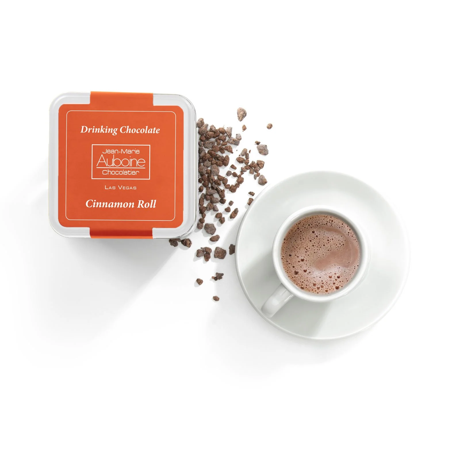 Gourmet cinnamon roll hot chocolate tin paired with a warm cup of cocoa.