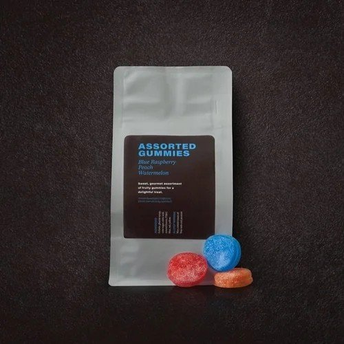 Custom-labeled assorted gummies in retail pouch packaging for hotel markets and grab-and-go displays.