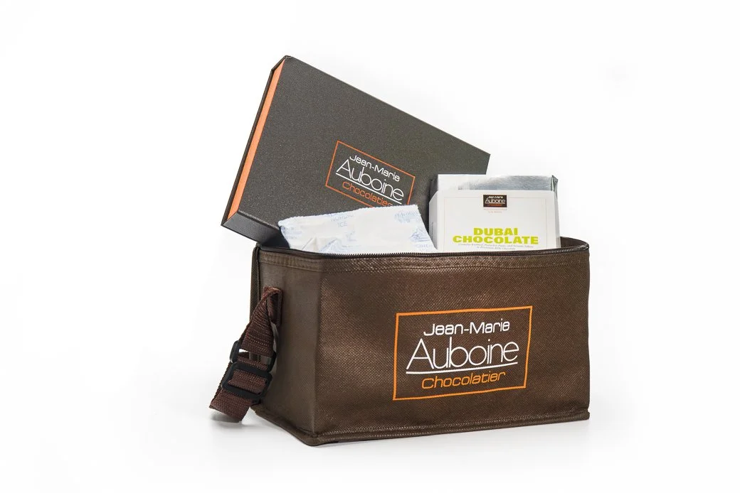 Jean-Marie Auboine branded bag filled with chocolates and chocolate boxes