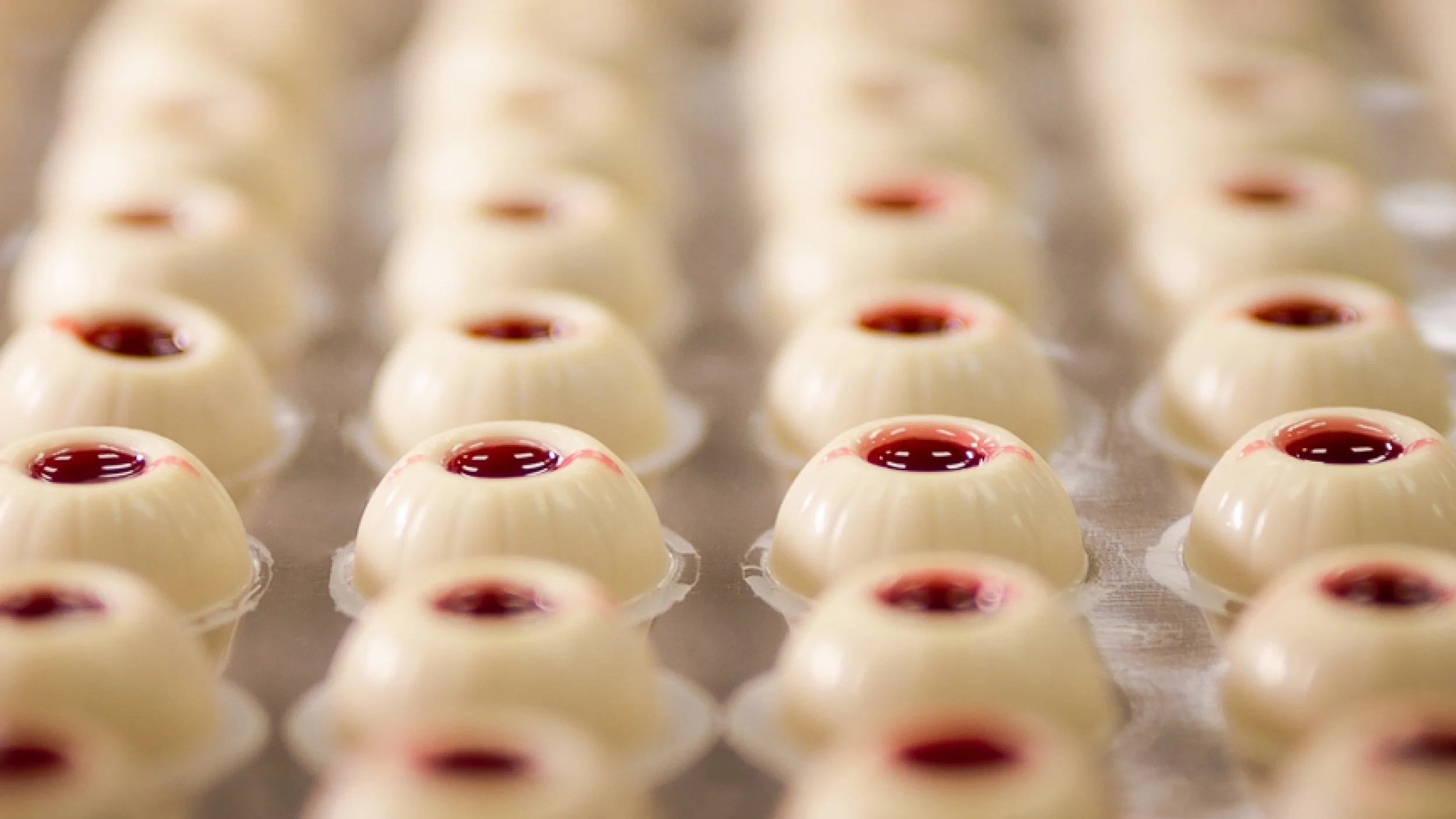 White chocolate shells filled with raspberry ganache