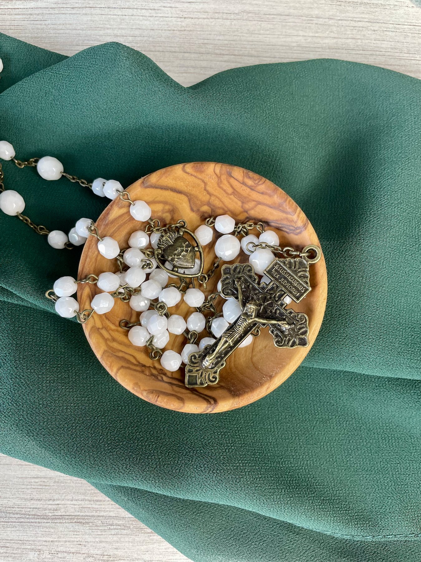 Faceted white beaded rosary with bronze chain links. Bronze pardon crucifix and bronze Sacred Heart centerpiece.