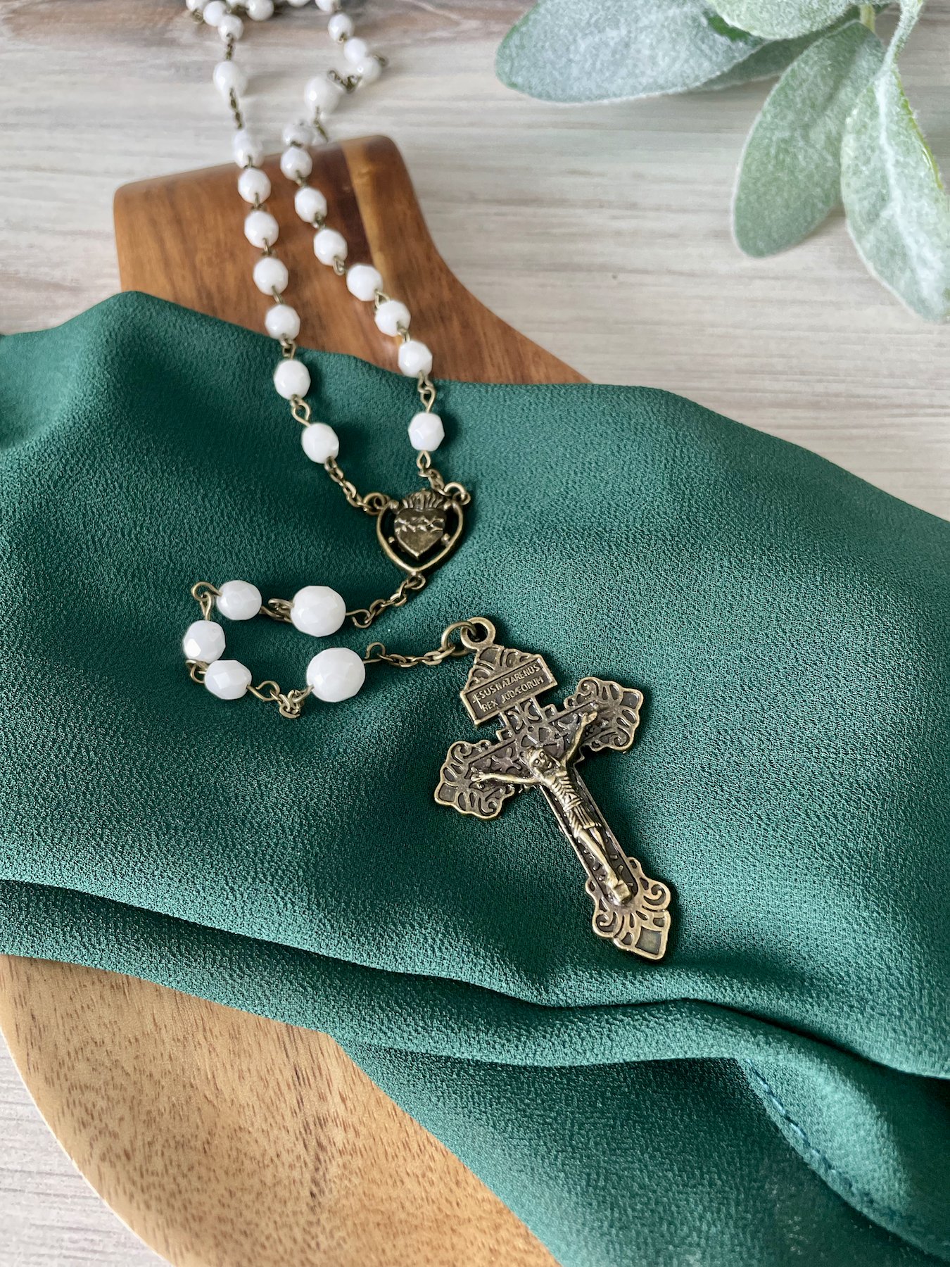 White beaded rosary with bronze chain links. Bronze pardon crucifix and bronze Sacred Heart centerpiece.
