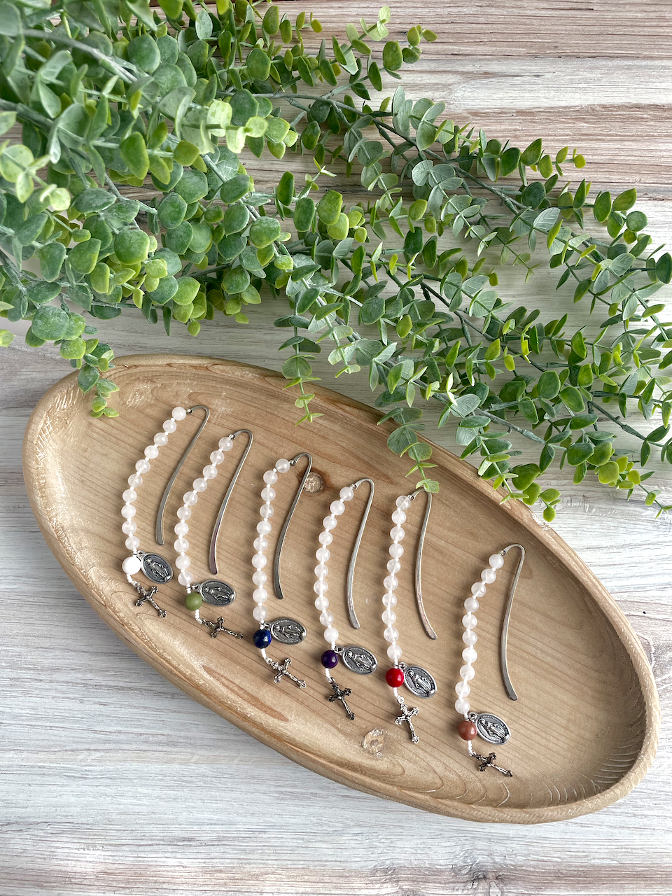 Natural gemstone bookmarks laid out on table, with enough beads to pray a decade of the rosary.